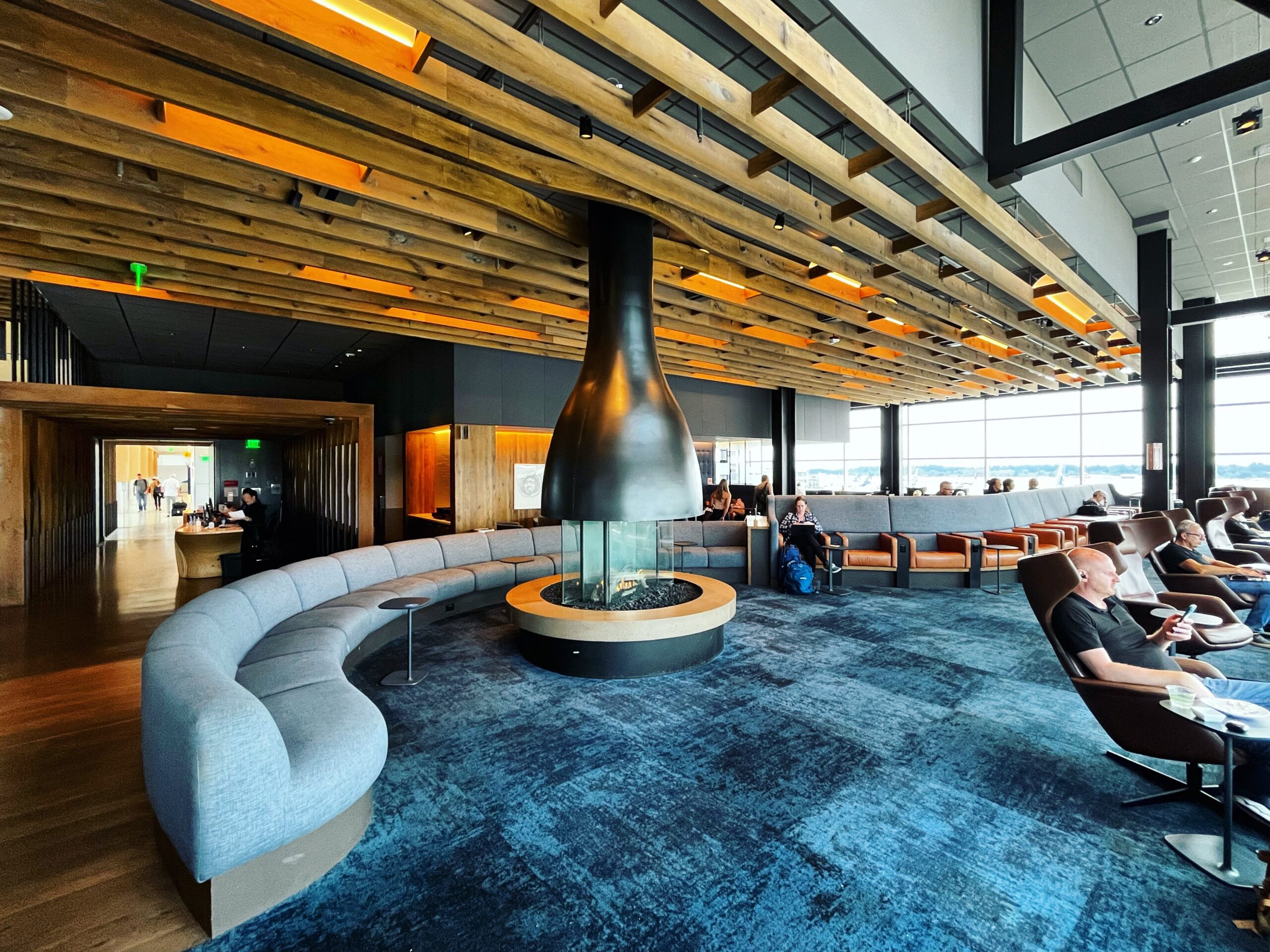 Modern airport lounge seating area with gas fireplace