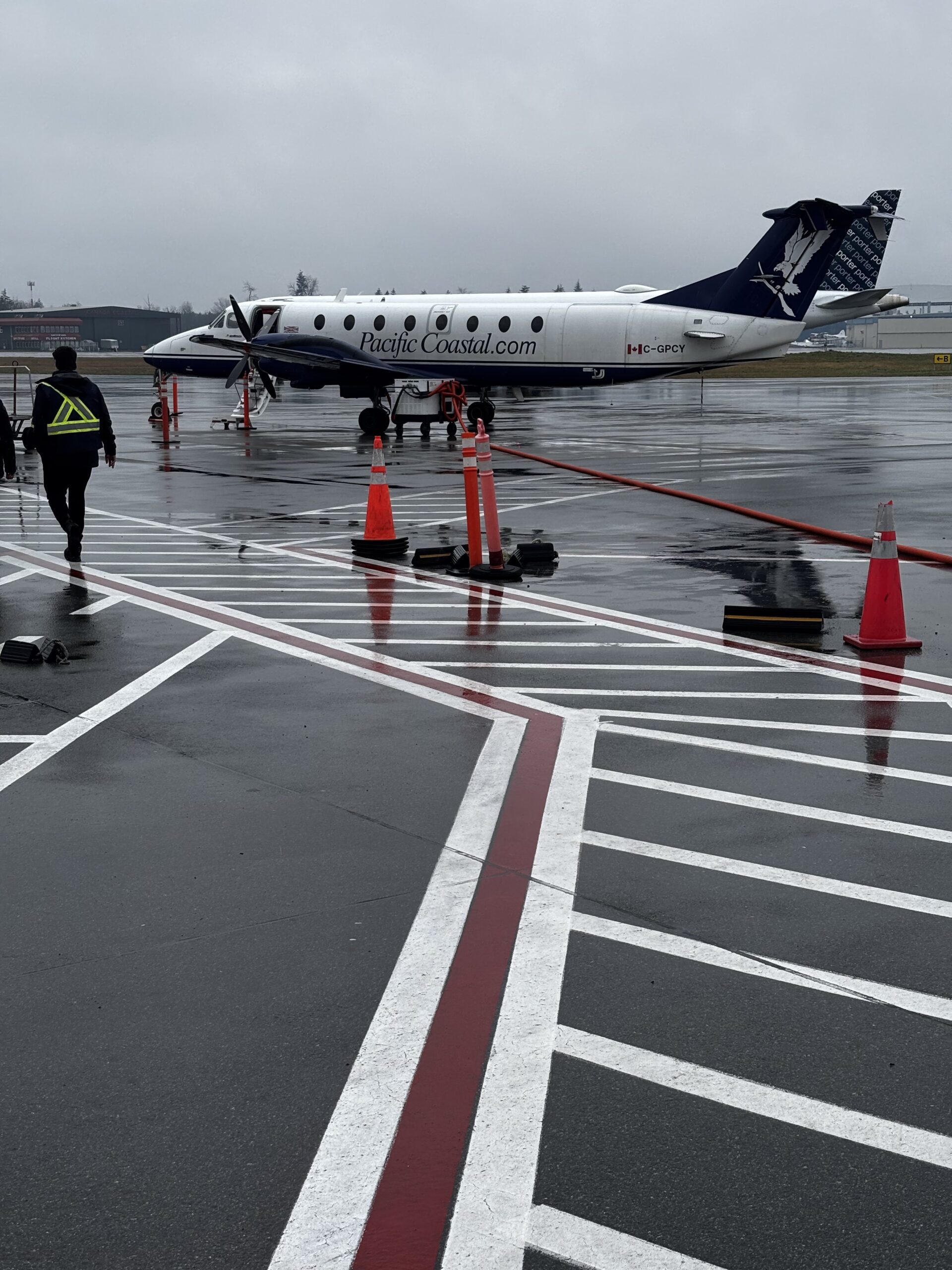 Pacific Coastal Airlines Beechcraft 1900 turboprop on rainy airport tarmac